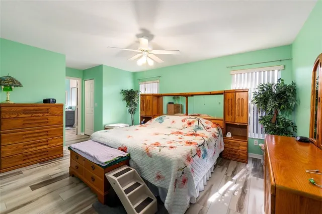 a bed sitting in a bedroom next to a window