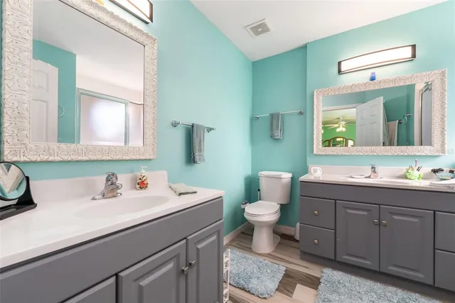 a bathroom with a sink mirror vanity and a toilet