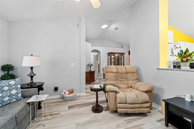 a living room with furniture and wooden floor