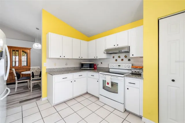 a kitchen with stainless steel appliances granite countertop a sink and cabinets