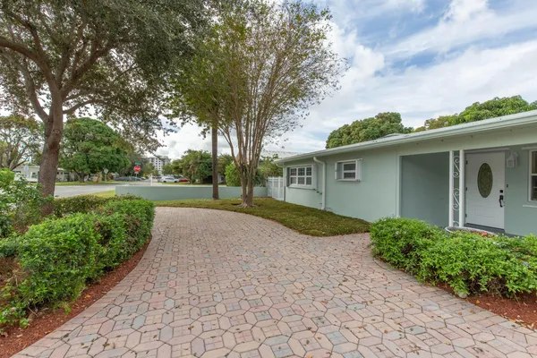 a pathway of a house with a yard