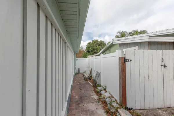 an empty room with windows and a ceiling fan
