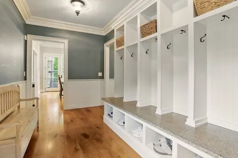 view of hall way with wooden floor and staircase