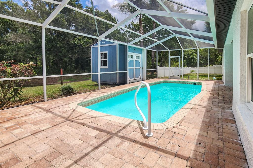 7027 Frascati Loop Wesley Chapel, FL 33544 - Photo 24 of 28 a view of a backyard with a swimming pool