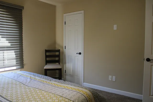 a bedroom with a bed and a window