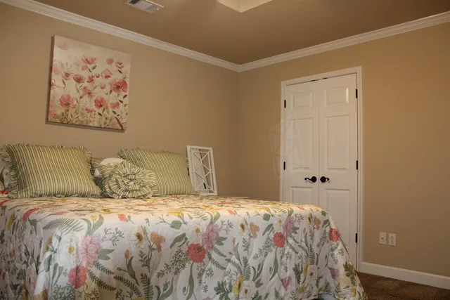 a large bed sitting in a bedroom next to a small yard