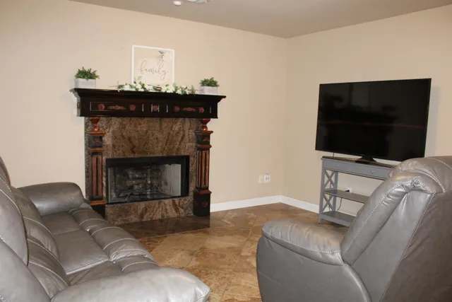 a living room with furniture and a fireplace