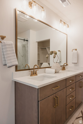 5902 Canyon Rim Road, Unit 620 Lehi, UT 84048 - Photo 48 of 78 Dual vanity featuring wood-finish cabinetry, white countertops, and gold-tone hardware