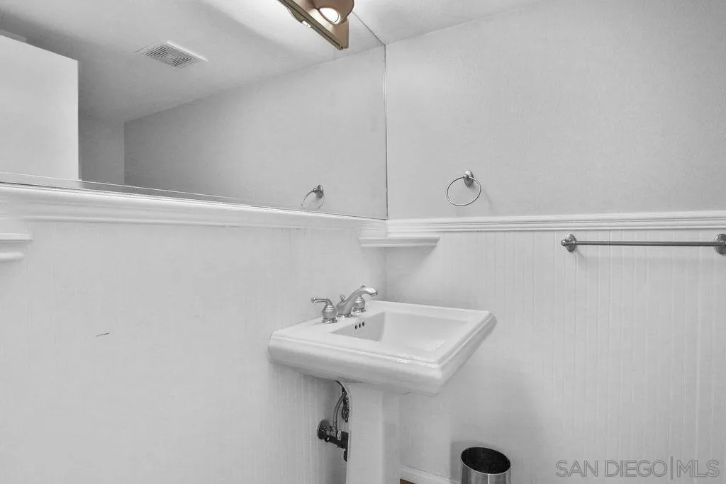 6359 Rancho Mission Road, Unit 7 San Diego, CA 92108 - Photo 12 of 25 a bathroom with a sink and mirror