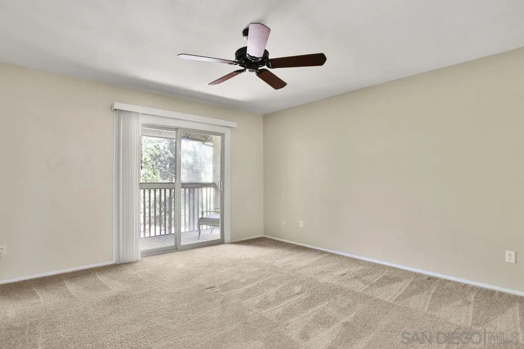 6359 Rancho Mission Road, Unit 7 San Diego, CA 92108 - Photo 13 of 25 a view of a livingroom with a ceiling fan and window