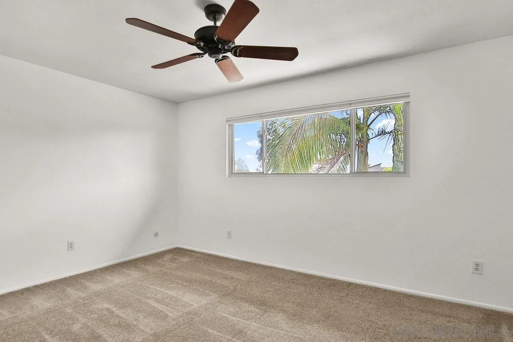 6359 Rancho Mission Road, Unit 7 San Diego, CA 92108 - Photo 18 of 25 an empty room with windows and fan
