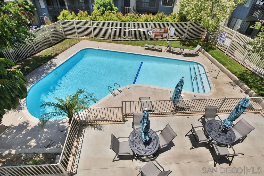6359 Rancho Mission Road, Unit 7 San Diego, CA 92108 - Photo 21 of 25 a view of a chairs and table in the back yard of the house