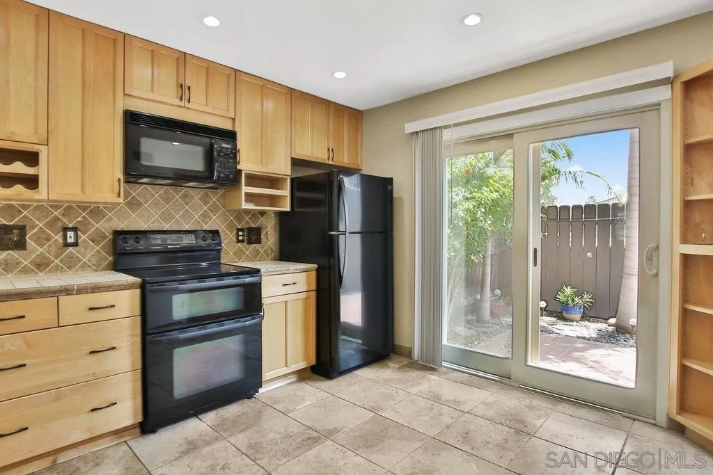 6359 Rancho Mission Road, Unit 7 San Diego, CA 92108 - Photo 8 of 25 a kitchen with a refrigerator stove and microwave