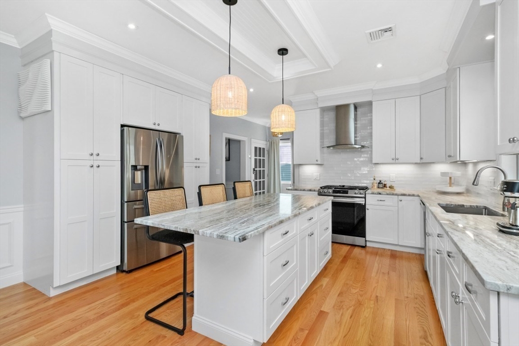 20 College Farm Road Waltham, MA 02451 - Photo 3 of 32 a large kitchen with stainless steel appliances granite countertop a sink a stove a refrigerator and a island
