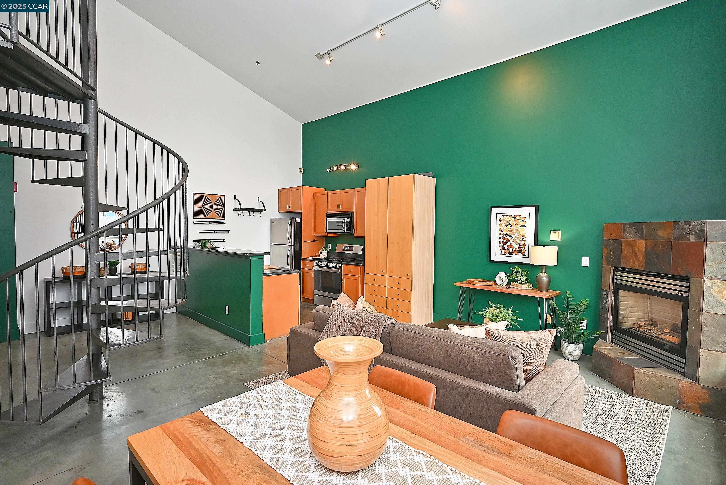 675 8th Street, Unit 15 Oakland, CA 94607 - Photo 11 of 38 a living room with furniture and a fireplace