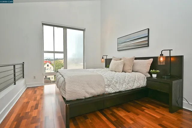 a bed sitting in a bedroom next to a window