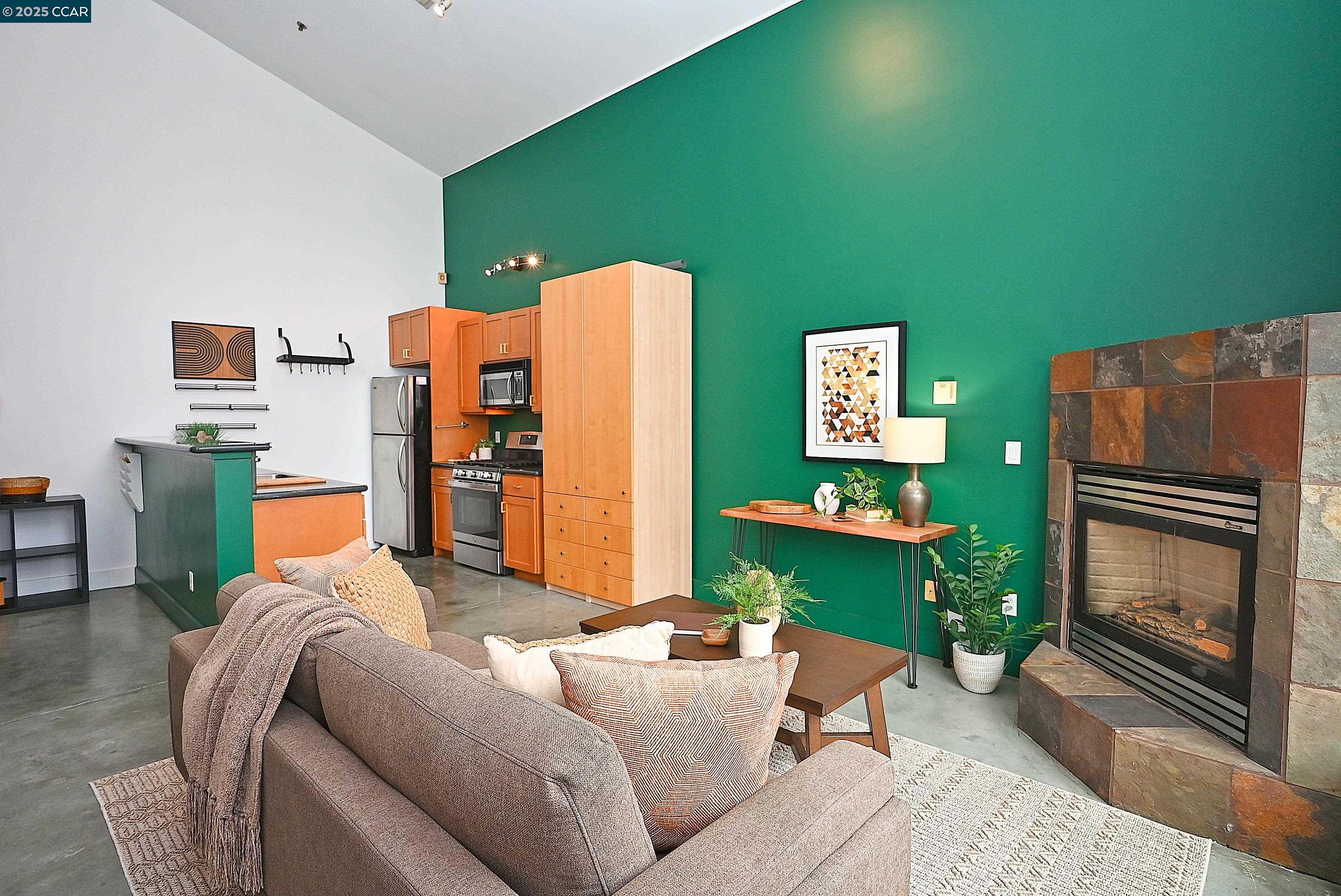 675 8th Street, Unit 15 Oakland, CA 94607 - Photo 10 of 38 a living room with furniture and a fireplace