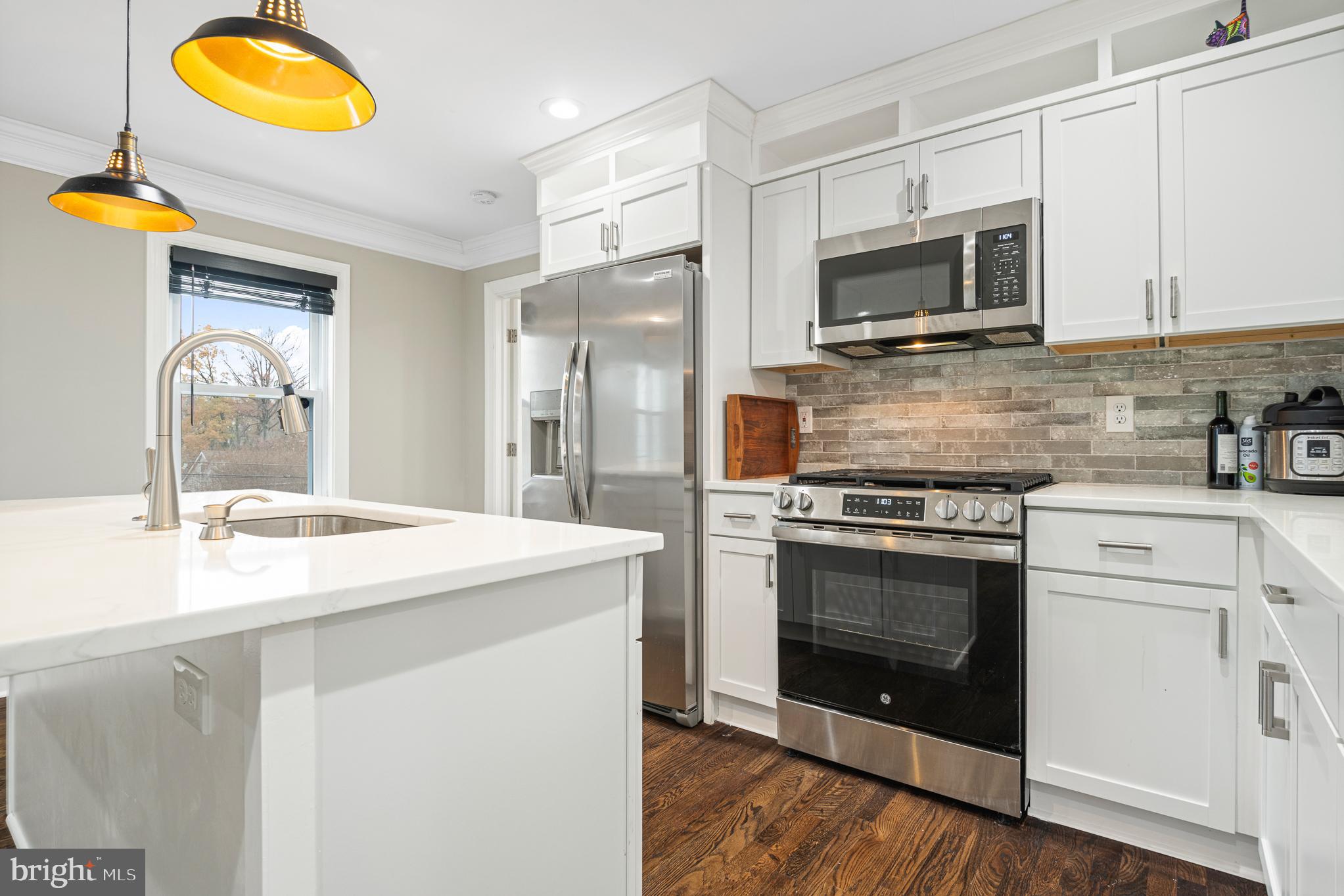 9217 Fowler Lane Lanham, MD 20706 - Photo 12 of 80 a kitchen with stainless steel appliances granite countertop a stove top oven microwave and cabinets
