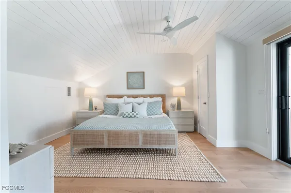 a bedroom with a bed and a night stand