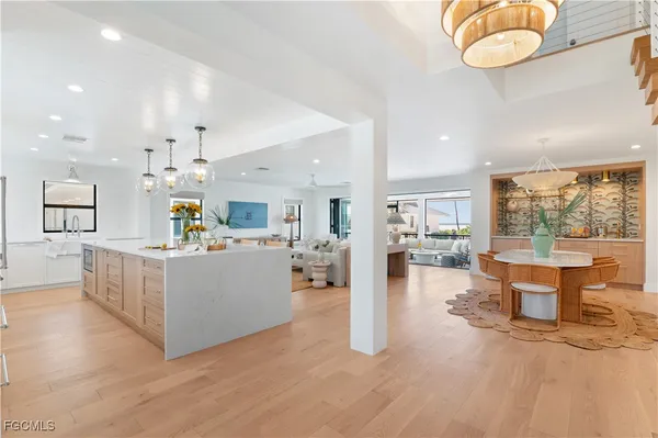 a kitchen with kitchen island a stove a sink a center island and a refrigerator