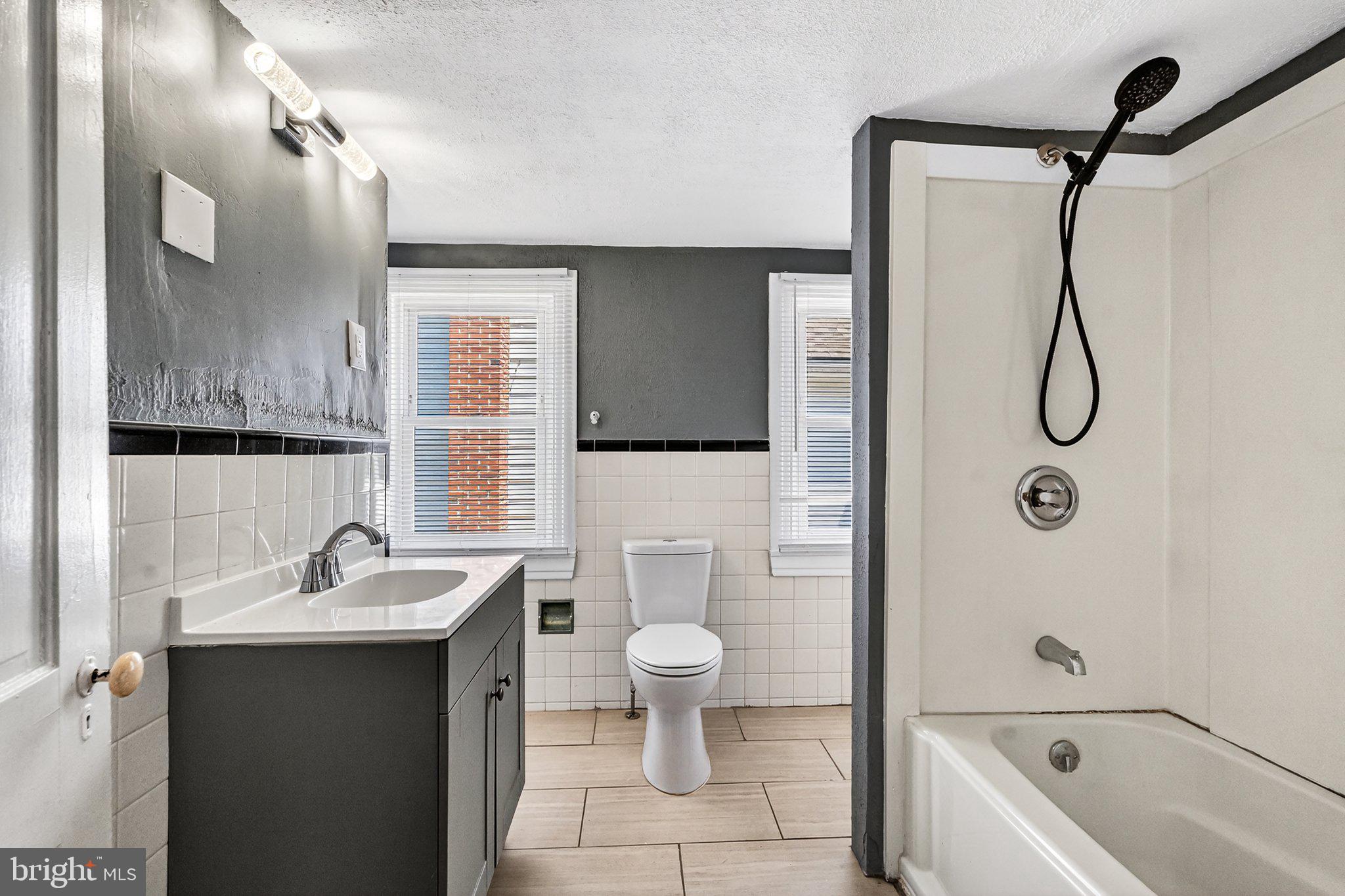 97 Chestnut Street Salem, NJ 08079 - Photo 19 of 38 a bathroom with a sink a toilet and shower