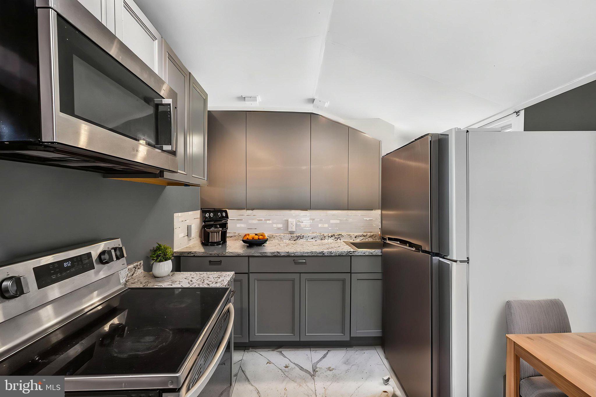 97 Chestnut Street Salem, NJ 08079 - Photo 32 of 38 a kitchen with stainless steel appliances granite countertop a refrigerator and a stove top oven