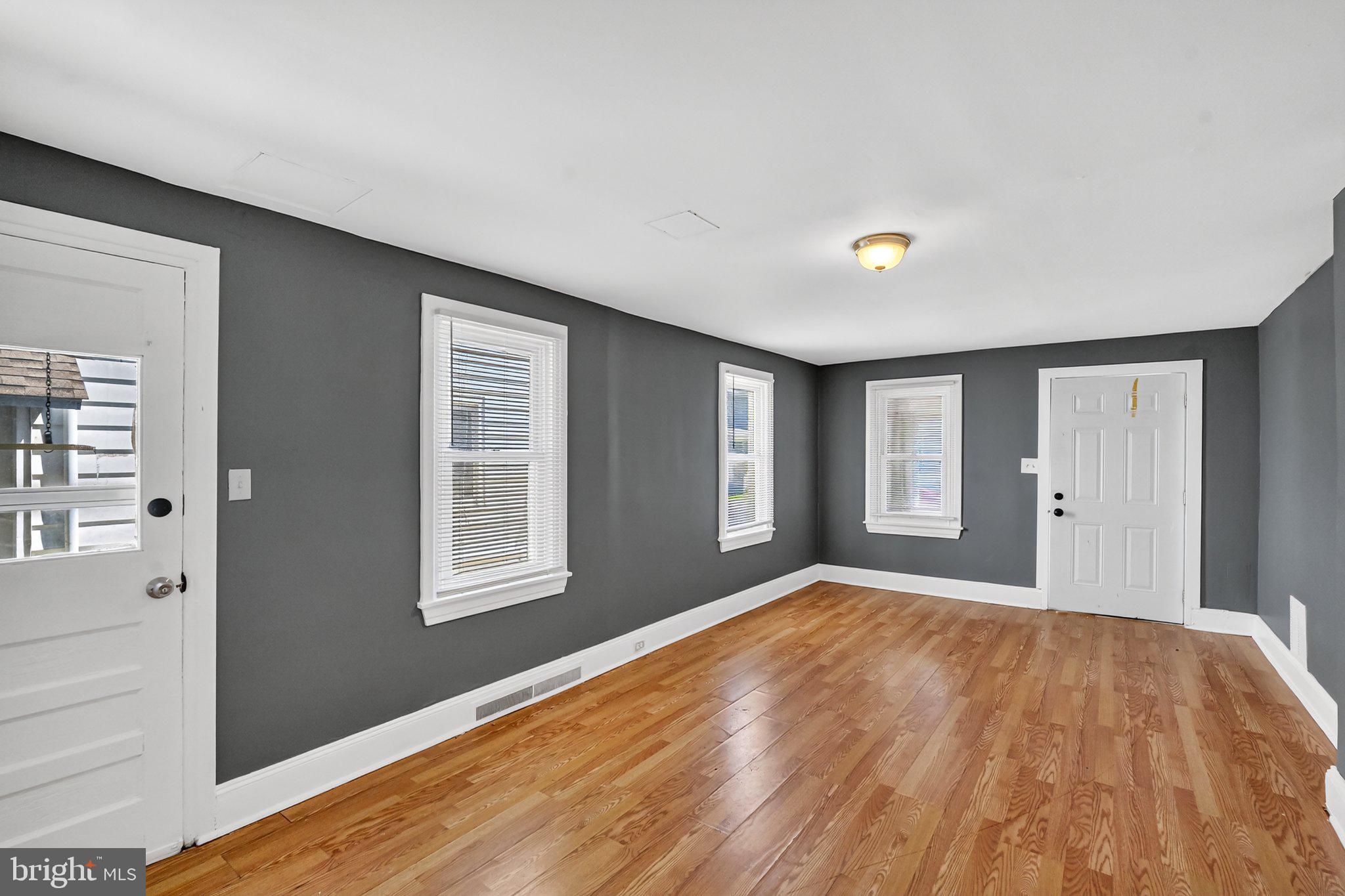 97 Chestnut Street Salem, NJ 08079 - Photo 6 of 38 a view of an empty room with wooden floor and a window