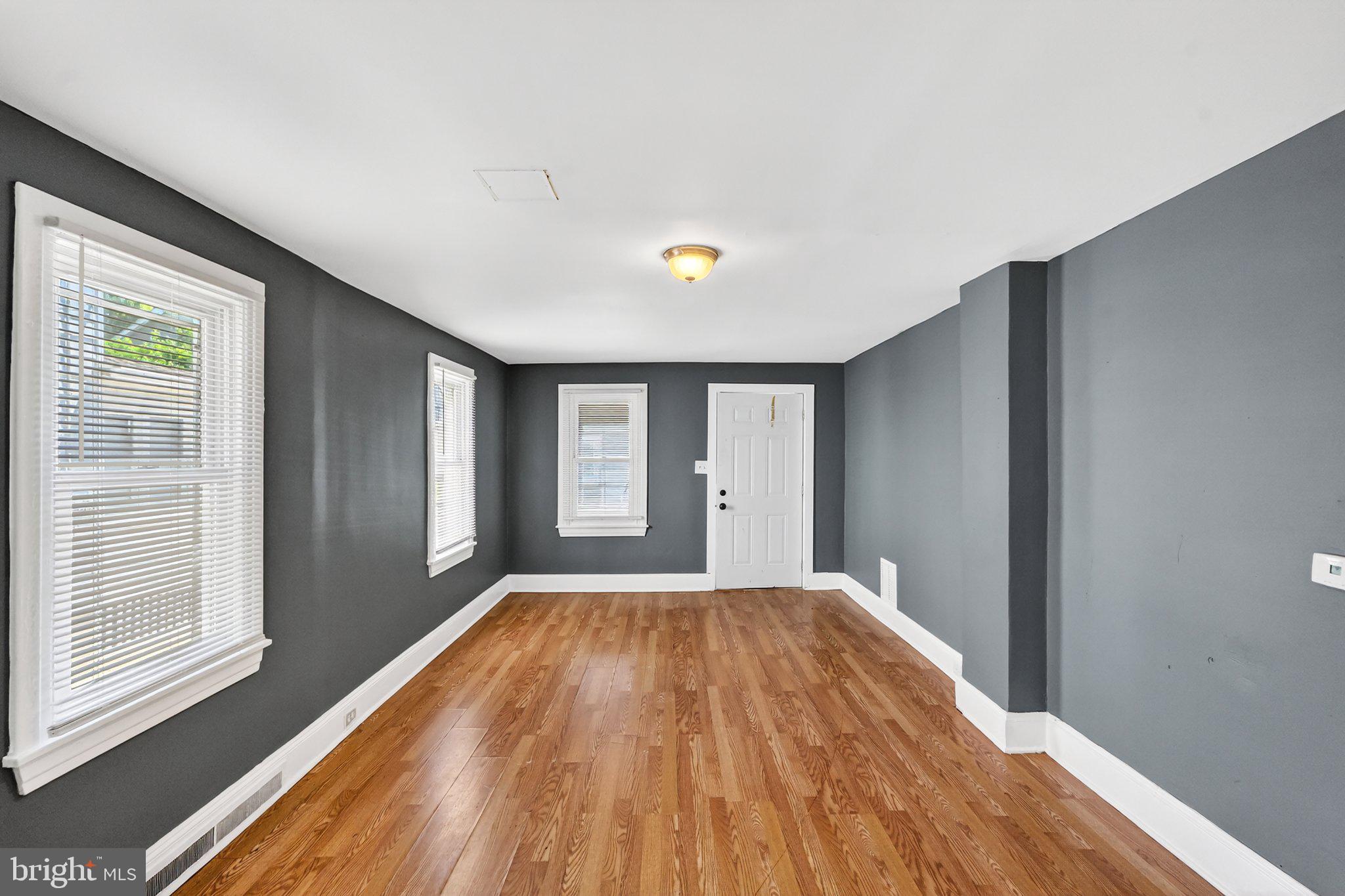 97 Chestnut Street Salem, NJ 08079 - Photo 7 of 38 a view of a livingroom with wooden floor and a window