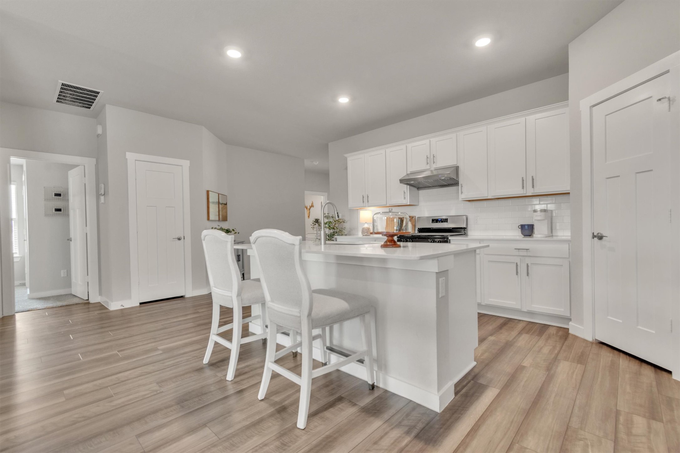 1008 Tipton Street Georgetown, TX 78633 - Photo 7 of 39 a kitchen with white cabinets and stainless steel appliances