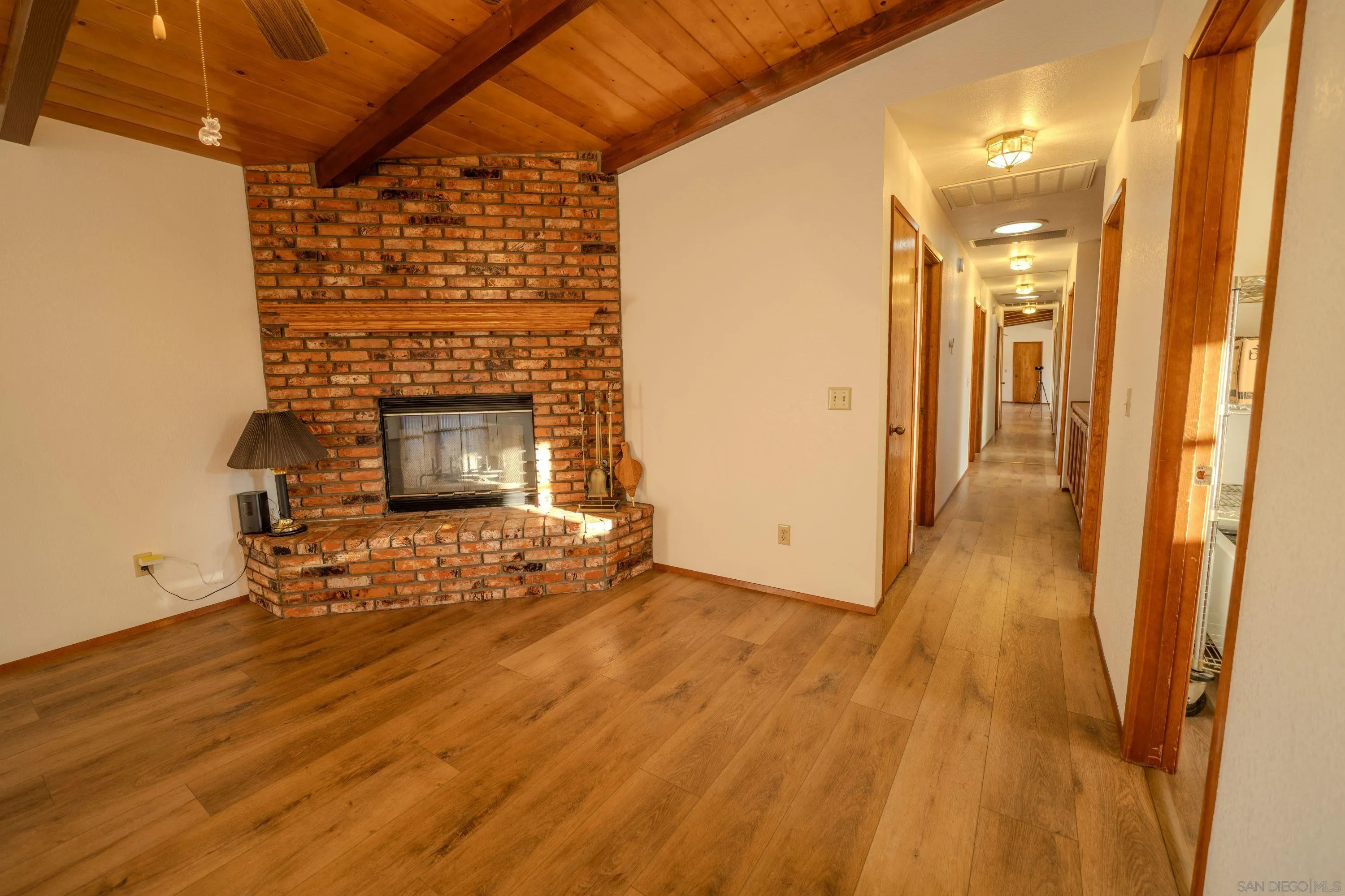 526 Brazos Street Ramona, CA 92065 - Photo 15 of 56 a view of empty room with wooden floor and fireplace