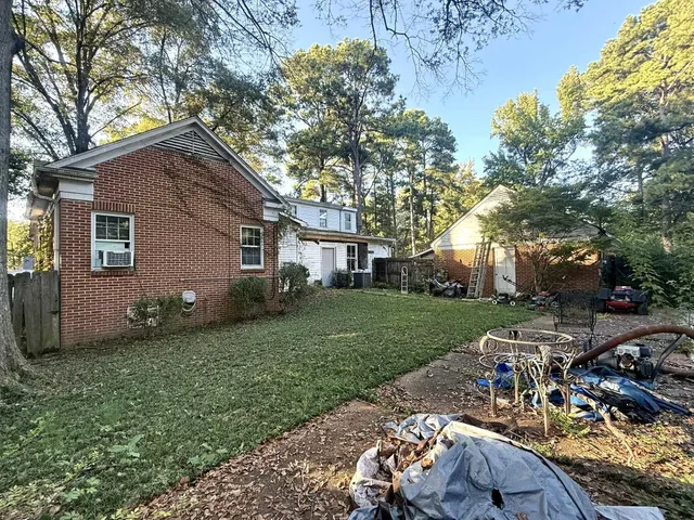 a view of a backyard with table and chairs and a fire pit