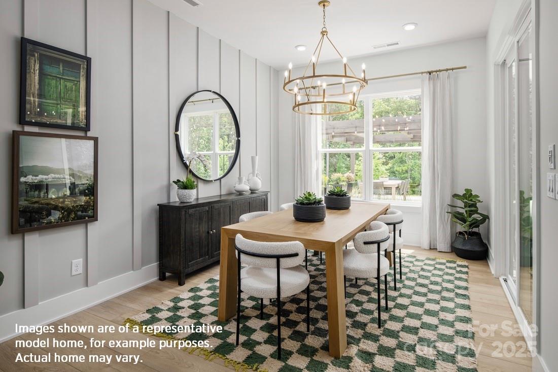 1081 Pinecone Avenue, Unit 213 Indian Land, SC 29707 - Photo 6 of 19 a view of a dining room with furniture window and wooden floor