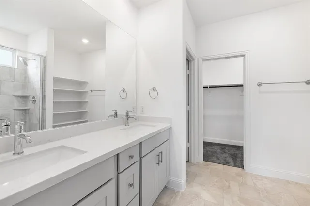 a spacious bathroom with a granite countertop sink and a mirror
