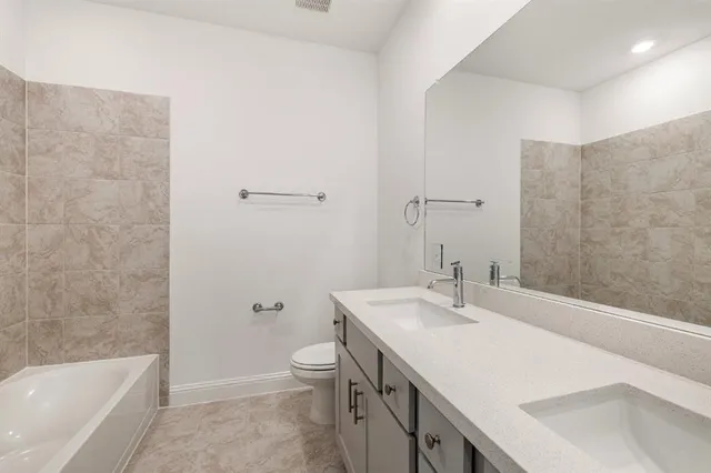 a bathroom with a sink a toilet and bathtub