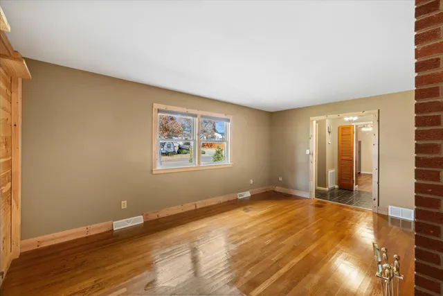 a kitchen with stainless steel appliances a sink cabinets and wooden floor