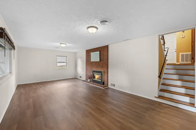 a view of a house with backyard and porch