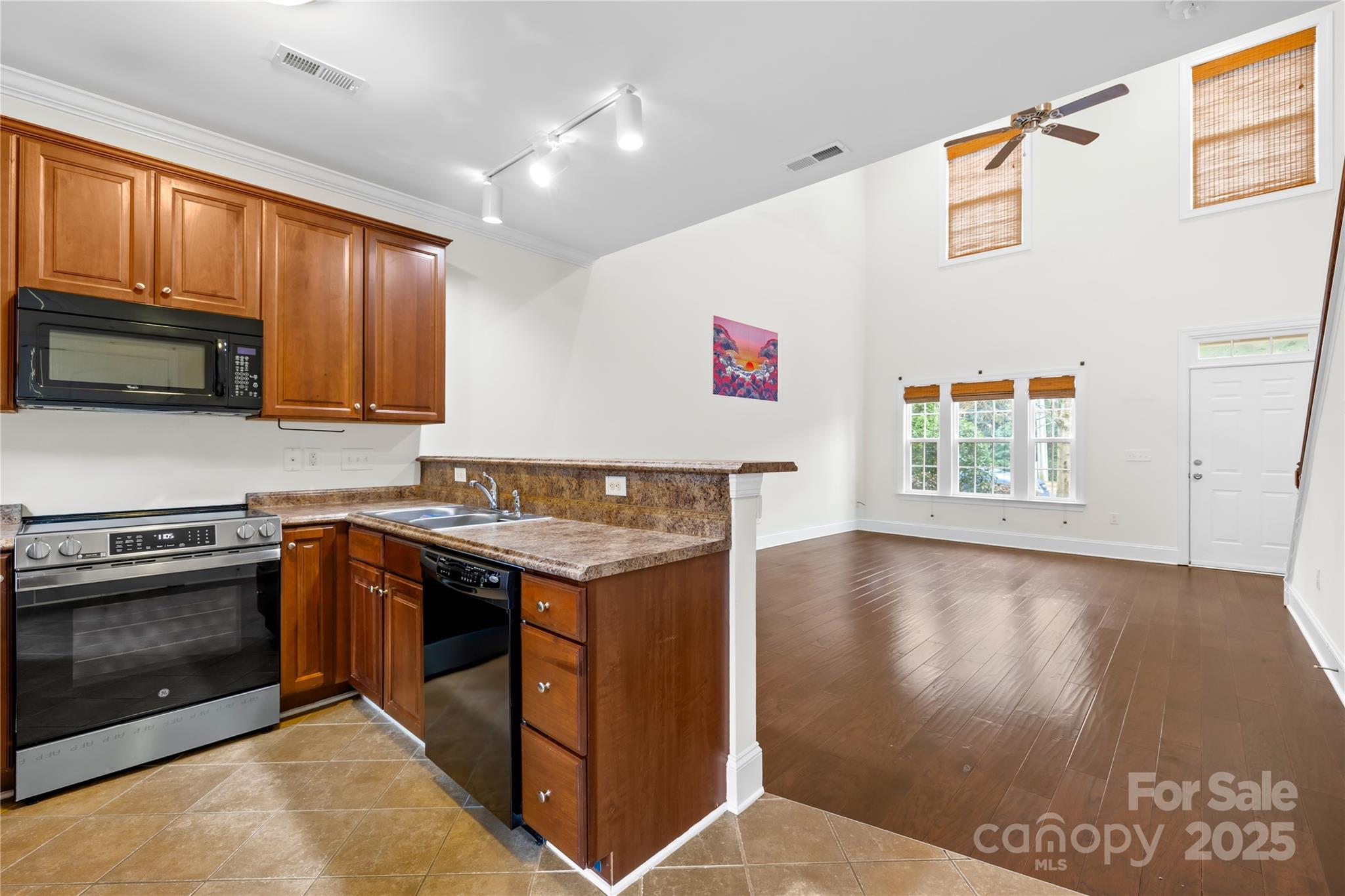 518 Armour Street Davidson, NC 28036 - Photo 17 of 26 a kitchen with stainless steel appliances granite countertop a stove a sink and a microwave
