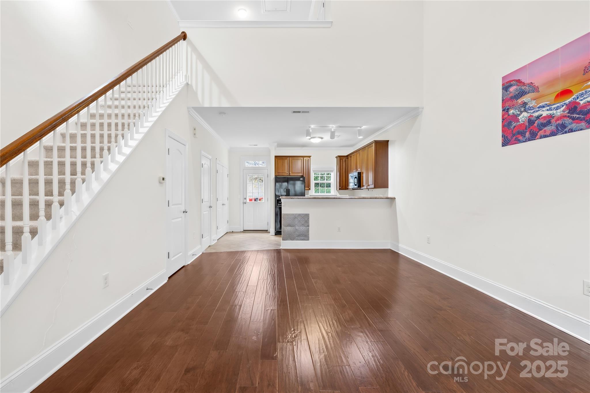 518 Armour Street Davidson, NC 28036 - Photo 3 of 26 a view of a hallway with wooden floor and staircase