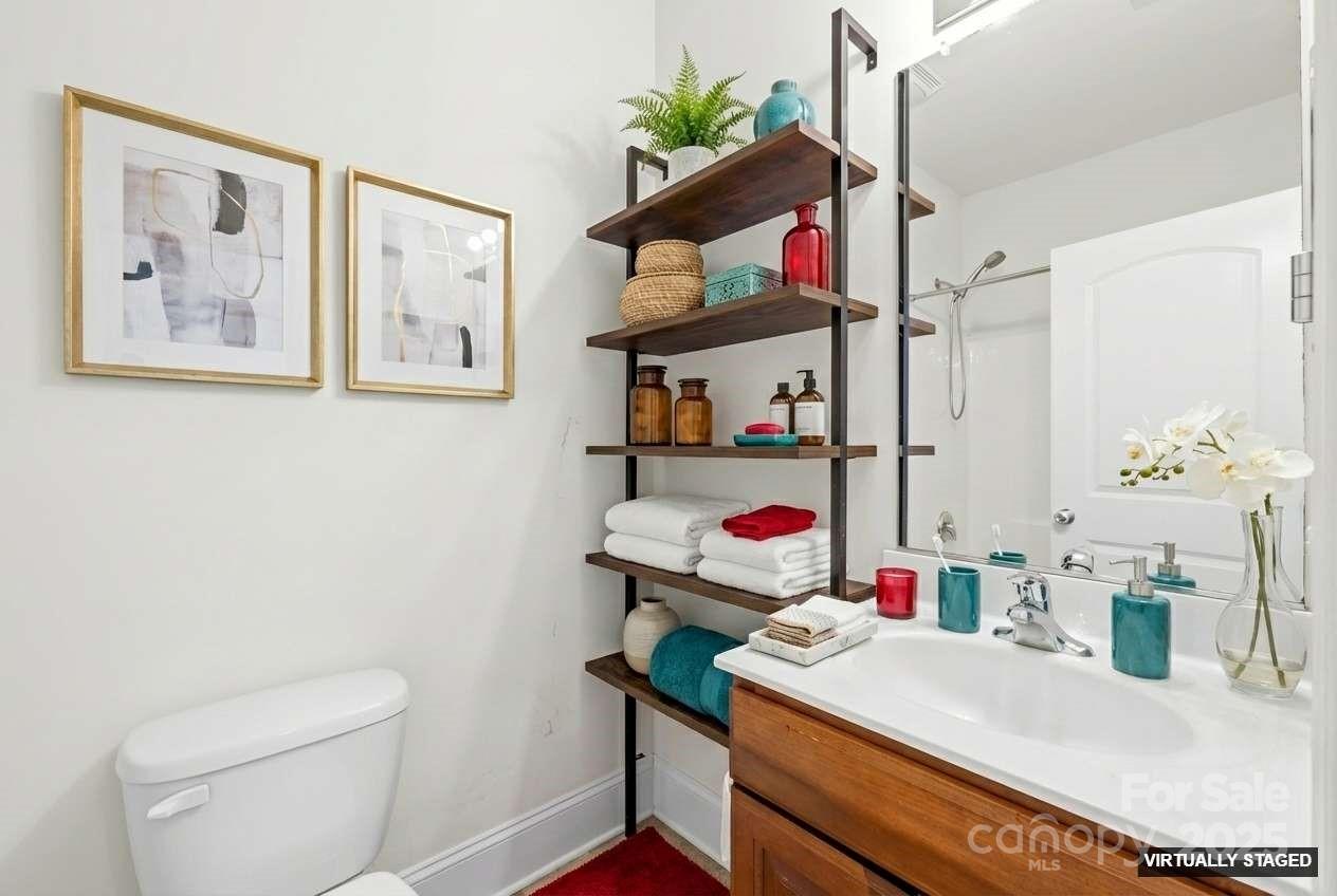 518 Armour Street Davidson, NC 28036 - Photo 7 of 26 a bathroom with a sink a toilet and a mirror