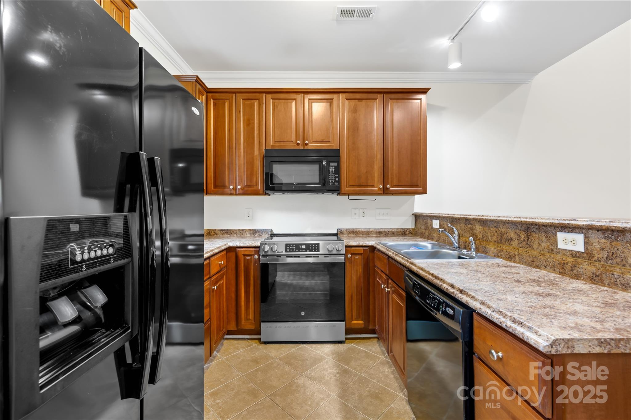518 Armour Street Davidson, NC 28036 - Photo 10 of 26 a kitchen with granite countertop stainless steel appliances and wooden cabinets