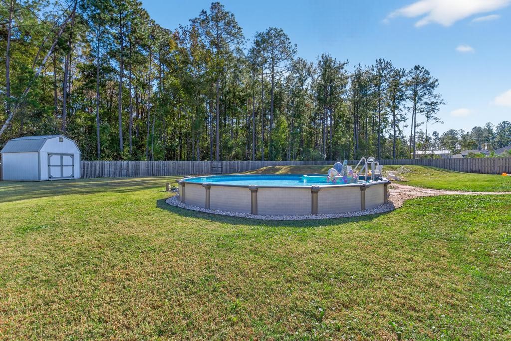 75774 Edwards Road Yulee, FL 32097 - Photo 55 of 70 a view of a house with a yard and sitting area