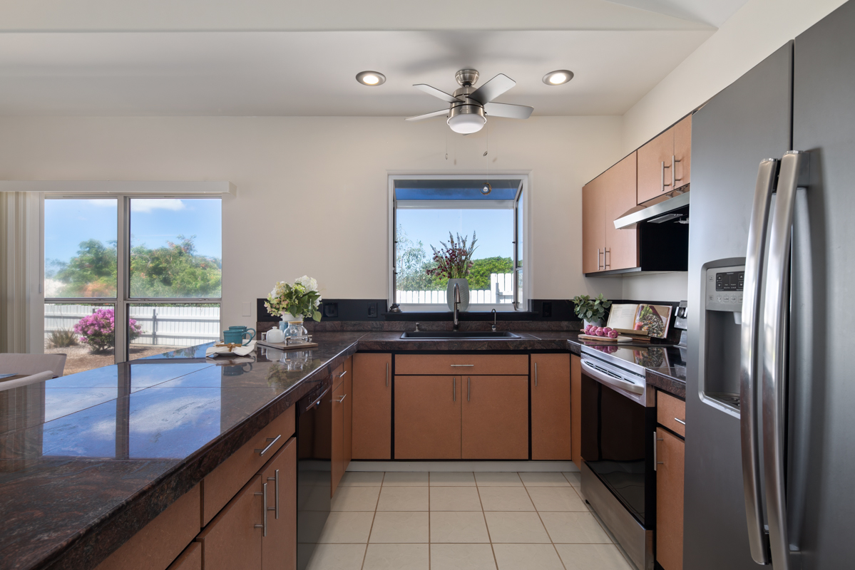 68-1704 Akaula Court Waikoloa, HI 96738 - Photo 13 of 30 a kitchen with stainless steel appliances a sink counter space cabinets and a large window