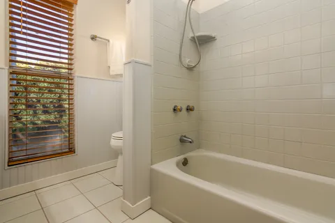 a bathroom with a bathtub and shower