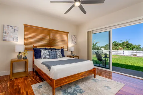 a bed sitting in a bedroom next to a window