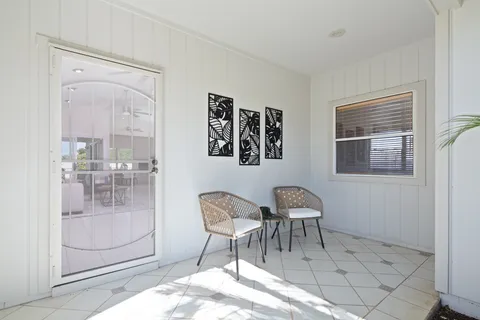 a dining room with furniture and glass door