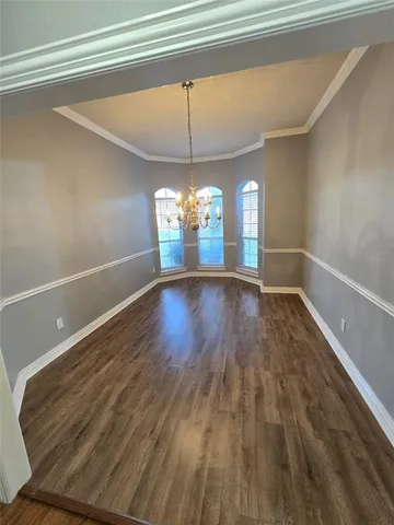 a view of a room with window and wooden floor