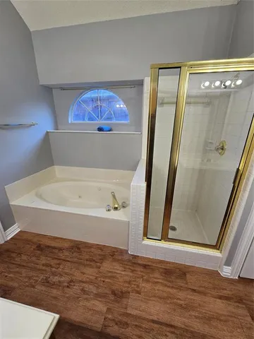 a bathroom with a tub and a shower