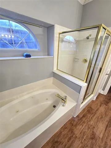 a bathroom with a tub and a shower