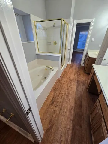 a bathroom with a bathtub and a shower