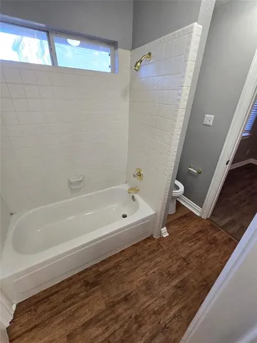 a bathroom with a tub a sink and a shower